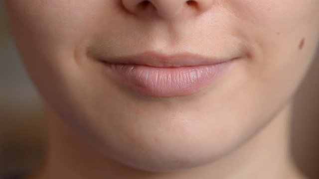 Close up of young caucasian woman licking her lips