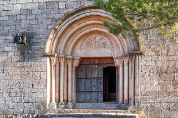 View of the main entrance to the church of Santa Maria de Siurana, in Siurana, Tarragona, Spain. Copy space for text.