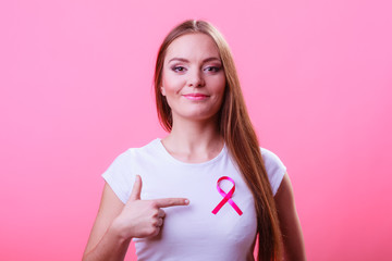 Woman wih pink cancer ribbon on chest