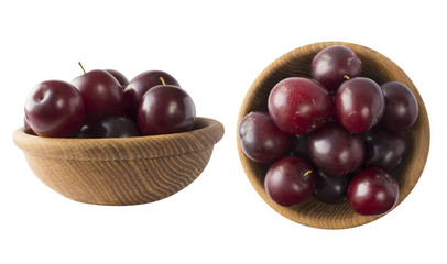 Bowl with plums isolated on white background. Ripe plums with copy space for text. Selective focus