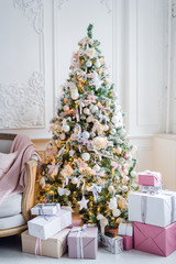 beautiful modern design of the room in delicate light colors decorated with Christmas tree and decorative elements