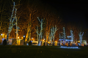 Fototapeta na wymiar Zrinjevac park decorated by Christmas lights as part of Advent in Zagreb
