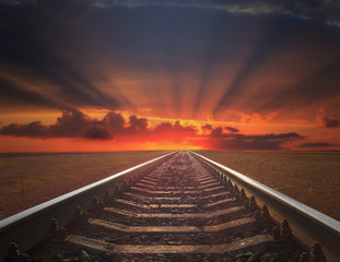 red sunset with rails going away