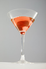 Cosmopolitan cocktail martini glass studio photo. Fashion cocktails. Red drink.