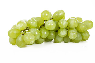 Healthy fruits Green wine grapes with isolated white background. Unwashed big wine green grapes on white background. Green grapes from a supermarket local market. Bunch of grapes ready to eat. Green.