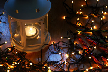 Set of white lantern with christmas lights and candy canes on the wooden floor.