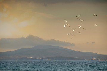 Sunset over a bay with mountains