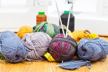 knitting materials on table and sewing machines