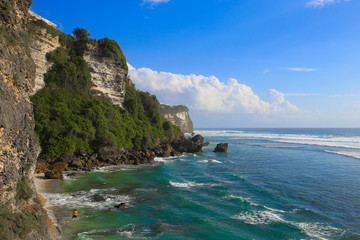 Scenic landscape of high cliff with fantastic blue sky at Uluwatu cliff. Travel Bali, Indonesia