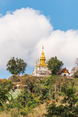 Naklejka premium View of the Buddhist temple on the mountain, Louangphabang, Laos. Copy space for text. Vertical.