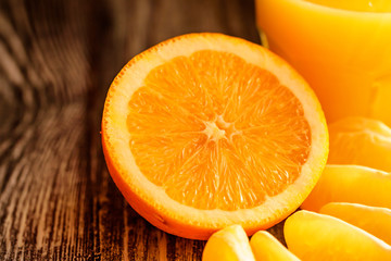 Oranges and orange juice on a wooden background