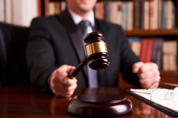 Male lawyer or judge hand's striking the gavel © Gecko Studio