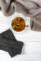 Cup of tea, knitted mittens and scarf