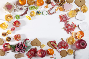 Christmas backdrop with sweets, candies, toys, apples and tangerines. Copy space