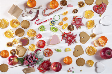 Christmas backdrop with sweets, candies, toys, apples and tangerines. Copy space