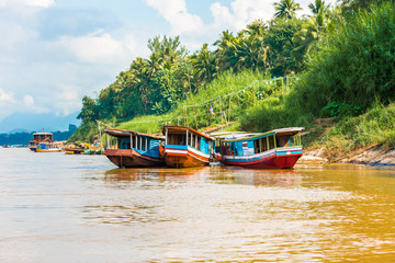 Boats near the bank of the river Nam Khan in Louangphabang, Laos. Copy space for text.