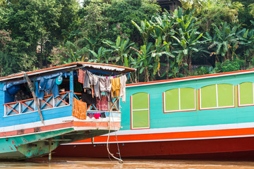 Fototapeta na wymiar Boats near the bank of the river Nam Khan in Louangphabang, Laos. Close-up.