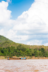 Boats near the bank of the river Nam Khan in Louangphabang, Laos. Copy space for text. Vertical.