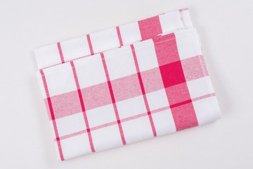 Fototapeta premium Background for product. Checked tablecloth in a red and white cage on white surface, view from above.