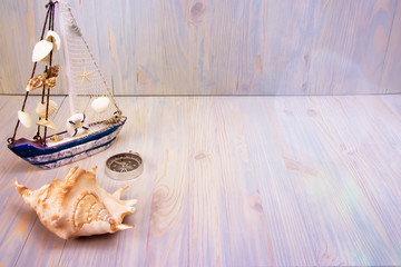 Fototapeta na wymiar sailboat, compass and seashell background for text or label