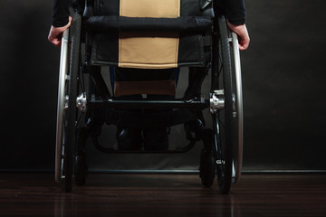 Disabled person sitting on wheelchair.