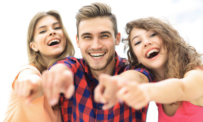 closeup of three happy young people showing hands forward