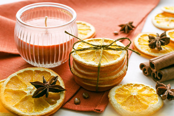 dried oranges, anise stars and cinnamon sticks with candle