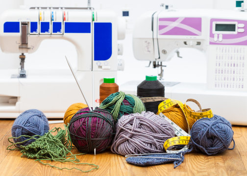 wool knitting yarn on table and sewing machines