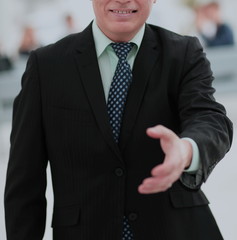 Mature friendly white-haired businessman in a modern office