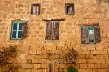 Fototapeta na wymiar Old wooden window on brown brick wall.