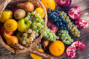 Composition with assorted fruits in wicker basket, healthy life