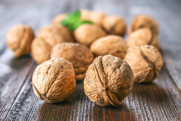 Shell and walnut bones on a brown wooden table.