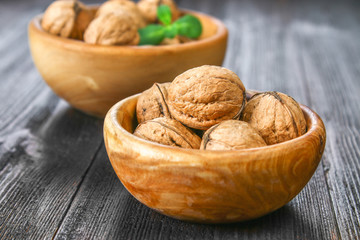 Shell and walnut bones on a brown wooden table.