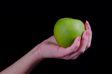 Green apple in girl hand