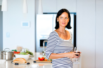 Beautiful woman holding glass with red wine