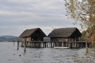 Fototapeta na wymiar Lake dwelling museum. Buildings on stilts at Lake Constance Germany Europe