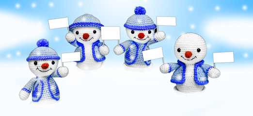  four happy snowman toys with advertising in the snow
