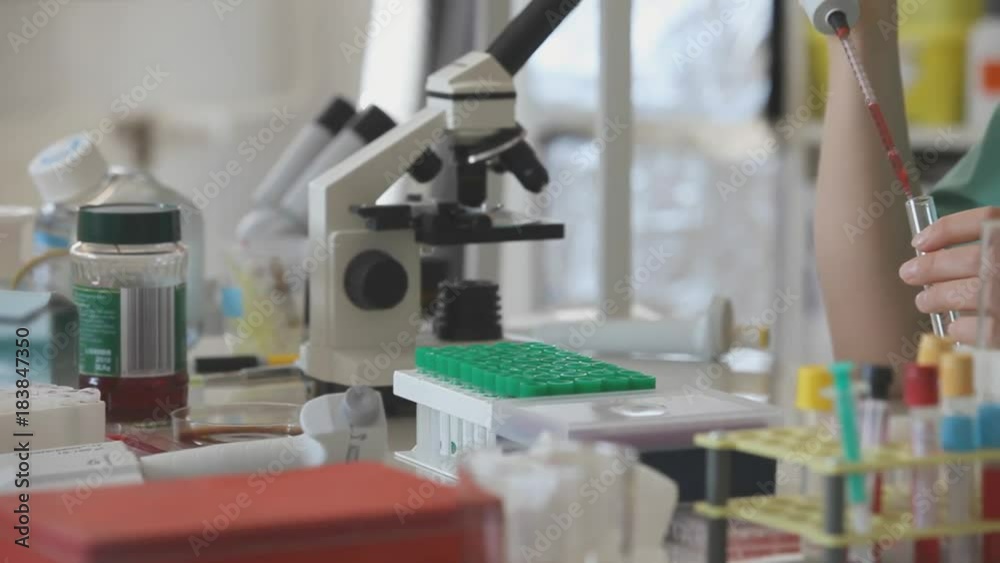 Sticker A scientist looks at a sample of a chemical in a laboratory.  Woman in the chemical laboratory