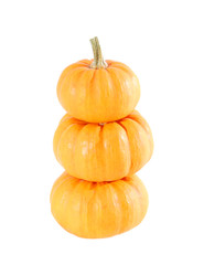 Three stacked mini pumpkins over white