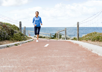 Young Woman Jogging On The Beach