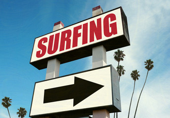 Fototapeta premium aged and worn surfing sign with palm trees