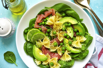 Pasta salad with spinach,avocado,salted salmon and green pea.Top view.