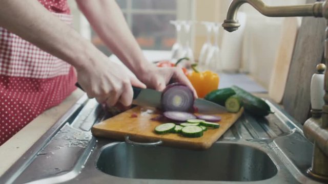 Man cuts onion in slowmotion