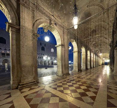 Ancient arches of Doges Palace on St. Marc Square in Venice at night