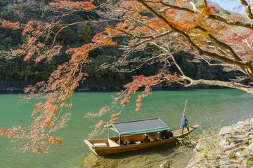 Beautiful fall color and Katsura River with boat