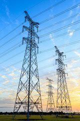 High voltage power tower landscape at sunset