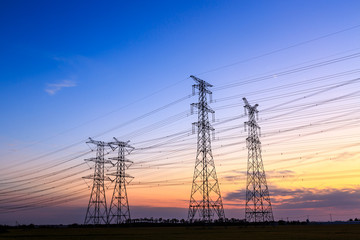 High voltage power tower landscape at sunset