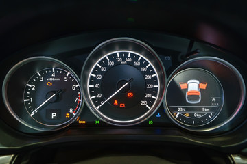 Modern light car mileage (dashboard, milage) isolated on a black background. New display of a modern car. RPM, Fuel indicator and temperature. Fuel economy.