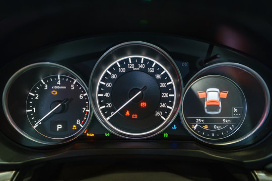 Modern light car mileage (dashboard, milage) isolated on a black background. New display of a modern car. RPM, Fuel indicator and temperature. Fuel economy.