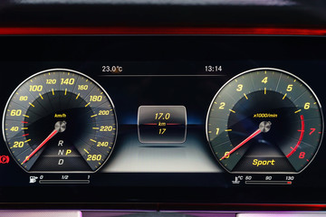 Modern light car mileage (dashboard, milage) isolated on a black background. New display of a modern car. RPM, Fuel indicator and temperature. Fuel economy.
